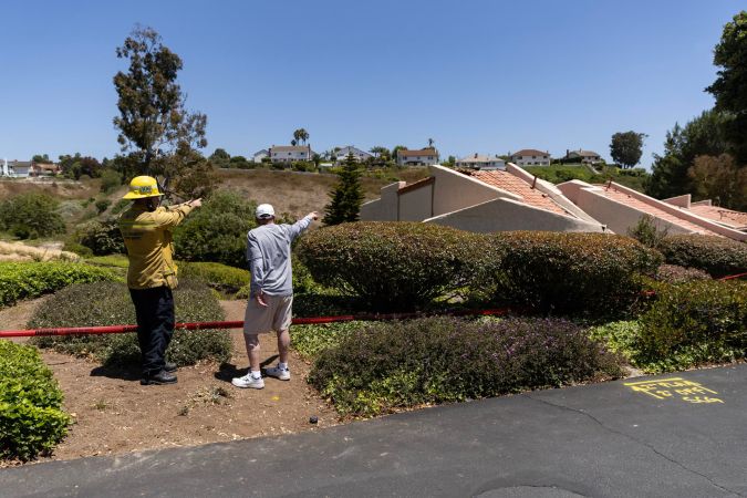 Los Angeles (United States), 09/07/2023.- Neighbors and firefighters point at a collapsed house in Rolling Hills Estates in Los Angeles, California, USA, 09 July 2023. A large landslide in Rolling Hills Estates this weekend forced 12 houses next to a canyon to be evacuated. (Incendio, Estados Unidos) EFE/EPA/ETIENNE LAURENT