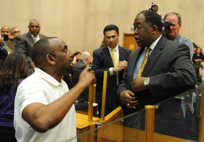 An anti-boycott protester (L) confronts Los Angeles County supervisor Mark Ridley-Thomas (R) after they voted 3-2 for Los Angeles County to join a boycott of the state of Arizona, in Los Angeles on June 1, 2010. The law -- Senate Bill 1070, which has not yet gone into effect, empowers local law enforcement in Arizona to check the immigration status of suspects they have stopped for other reasons if there is a reasonable suspicion they are in the country illegally. It specifically bars police from racial profiling. The motion directs the county's chief executive officer to send a letter to Arizona Gov. Jan Brewer and other state leaders calling for the repeal of the law; suspend all travel to the state for county business unless the travel is considered imperative; ban county investments in Arizona securities such as state or municipal bonds; and review all contracts with Arizona-based or headquartered companies and report on how those contracts can be terminated. AFP PHOTO/Mark RALSTON (Photo credit should read MARK RALSTON/AFP via Getty Images)