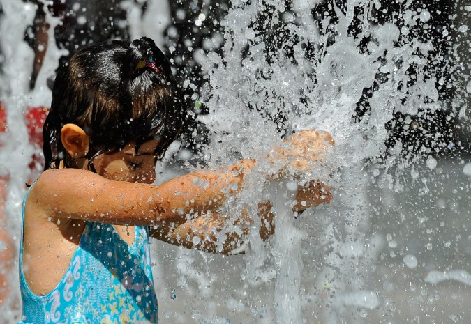 LOS ANGELES, CA - SEPTEMBER 27: Natalie Voroyan, 4, plays with the water jets in the fountain of the Hollywood and Highland shopping complex on September 27, 2010 in Los Angeles, California. The heat wave continues to bring hot temperatures to the Southland. (Photo by Kevork Djansezian/Getty Images)
