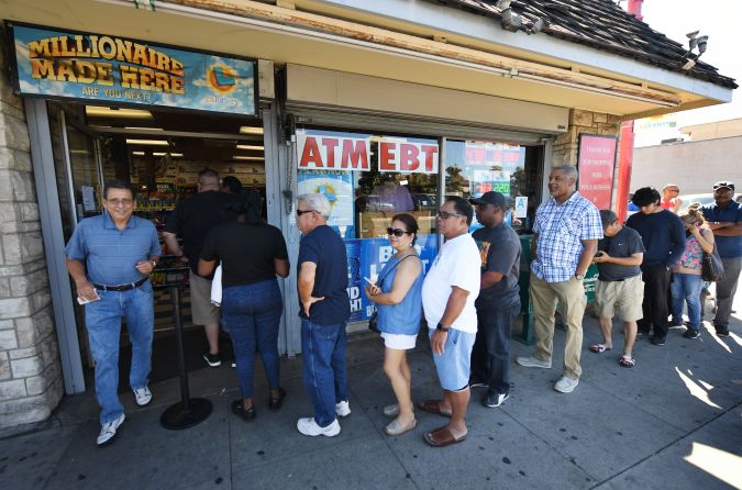 Customers buy Mega Millions tickets hours before the draw of the USD 1 billion jackpot, at the Bluebird Liquor store in Torrance, California on October 19, 2018. (Photo by Mark RALSTON / AFP) (Photo credit should read MARK RALSTON/AFP via Getty Images)