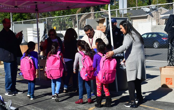 Telfair Elementary school children receive new backpacks during a morning to Operation School Bell on February 8, 2019 in Pacoima, California, some thirty minutes drive north of downtown Los Angeles, where the children receive new items such as backpacks, shoes and clothing. - For Jose Razo, principal at Telfair Elementary School in Los Angeles county, his students should spend their time worrying about homework, their grades or playdates. But the harsh reality for more than a quarter of the 720 children at the school is otherwise."Food, somewhere to sleep, something to put on their back: those are the challenges our students are facing," says Razo. "Someone seven or eight years old should not have to worry about that." (Photo by Frederic J. BROWN / AFP) (Photo credit should read FREDERIC J. BROWN/AFP via Getty Images)