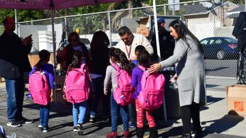 Telfair Elementary school children receive new backpacks during a morning to Operation School Bell on February 8, 2019 in Pacoima, California, some thirty minutes drive north of downtown Los Angeles, where the children receive new items such as backpacks, shoes and clothing. - For Jose Razo, principal at Telfair Elementary School in Los Angeles county, his students should spend their time worrying about homework, their grades or playdates. But the harsh reality for more than a quarter of the 720 children at the school is otherwise."Food, somewhere to sleep, something to put on their back: those are the challenges our students are facing," says Razo. "Someone seven or eight years old should not have to worry about that." (Photo by Frederic J. BROWN / AFP) (Photo credit should read FREDERIC J. BROWN/AFP via Getty Images)
