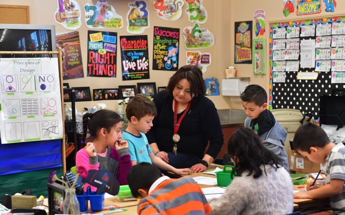 Telfair Elementary School first grade teacher Ms. Gutierrez works with her students on February 8, 2019 in Pacoima, California, some thirty minutes drive north of downtown Los Angeles. - For Jose Razo, principal at Telfair Elementary School in Los Angeles county, his students should spend their time worrying about homework, their grades or playdates. But the harsh reality for more than a quarter of the 720 children at the school is otherwise."Food, somewhere to sleep, something to put on their back: those are the challenges our students are facing," says Razo. "Someone seven or eight years old should not have to worry about that." (Photo by Frederic J. BROWN / AFP) (Photo credit should read FREDERIC J. BROWN/AFP via Getty Images)
