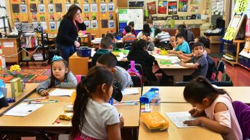 Telfair Elementary School first grade teacher Ms. Gutierrez works with her students on February 8, 2019 in Pacoima, California, some thirty minutes drive north of downtown Los Angeles. - For Jose Razo, principal at Telfair Elementary School in Los Angeles county, his students should spend their time worrying about homework, their grades or playdates. But the harsh reality for more than a quarter of the 720 children at the school is otherwise."Food, somewhere to sleep, something to put on their back: those are the challenges our students are facing," says Razo. "Someone seven or eight years old should not have to worry about that." (Photo by Frederic J. BROWN / AFP) (Photo credit should read FREDERIC J. BROWN/AFP via Getty Images)