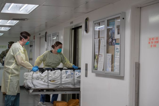 LOS ANGELES, CA - MARCH 29: In this handout released by the U.S. Navy, Sailors assigned to the hospital ship USNS Mercy (T-AH 19) transport the first patient from Los Angeles medical facilities March 29. Mercy deployed in support of the nation's COVID-19 response efforts, and will serve as a referral hospital for non-COVID-19 patients currently admitted to shore-based hospitals. This allows shore base hospitals to focus their efforts on COVID-19 cases. One of the Department of Defense's missions is Defense Support of Civil Authorities. DOD is supporting the Federal Emergency Management Agency, the lead federal agency, as well as state, local and public health authorities in helping protect the health and safety of the American people. (Photo by U.S. Navy via Getty Images)