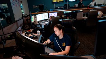 A dispatcher with Anne Arundel County Fire Department answers a 911 emergency call from their department dispatch center on April 14, 2020 in Glen Burnie, Maryland. - RESTRICTED TO EDITORIAL USE (Photo by Alex Edelman / AFP) / RESTRICTED TO EDITORIAL USE (Photo by ALEX EDELMAN/AFP via Getty Images)