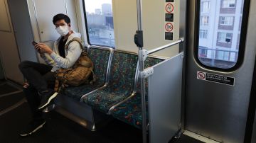 LOS ANGELES, CALIFORNIA - APRIL 01: A man wears a face mask while riding a Los Angeles Metro Rail train amid the coronavirus pandemic on April 1, 2020 in Los Angeles, California. As of last week, L.A. Metro ridership was down an estimated 81 percent on rail and 68 percent on buses amid the spread of COVID-19. L.A. Metro’s trains and buses are cleaned daily and the agency is now encouraging riders to social distance and only board for ‘essential’ trips. (Photo by Mario Tama/Getty Images)