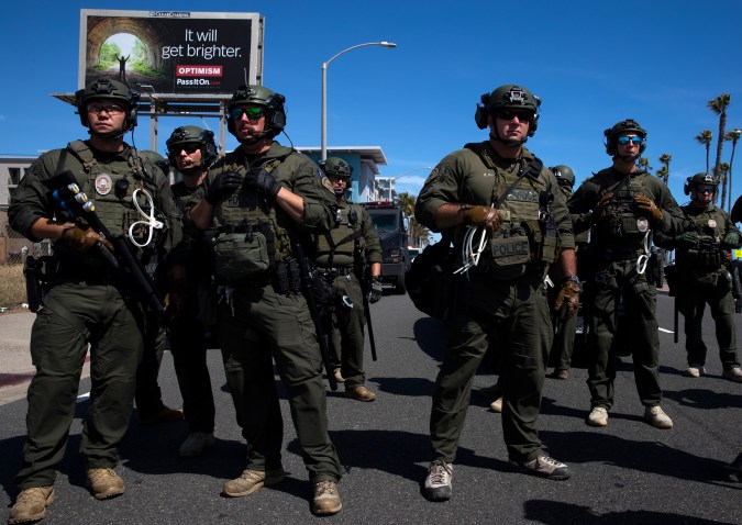 HUNTINGTON BEACH, CA - MAY 31: Huntington Beach SWAT team members stand ready for protesters after violent demonstrations in response to George Floyd's death on May 31, 2020 in Huntington Beach, California. California Governor Gavin Newsom has deployed National Guard troops to Los Angeles to curb the looting and destruction of property. Protesters have been demonstrating after video emerged of a Minneapolis police officer, Derek Chauvin, pinning Floyd's neck to the ground. Floyd was later pronounced dead while in police custody after being transported to Hennepin County Medical Center. The four officers involved in the incident have been fired and Chauvin has been arrested and charged with 3rd degree murder. (Photo by Brent Stirton/Getty Images)