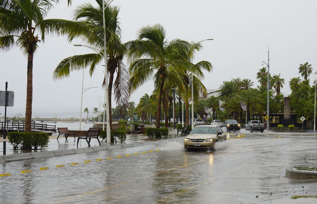 A car rides through a flooded street during the passage of tropical storm Olaf in La Paz, Baja California Sur, Mexico, on September 10, 2021. - Tropical storm Olaf swept across Mexico's Baja California peninsula on Friday, bringing strong winds and heavy rain to the major beach resorts of Los Cabos before losing its hurricane force. (Photo by JOEL COSIO / AFP) (Photo by JOEL COSIO/AFP via Getty Images)