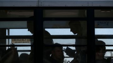 Ukrainians seeking for asylum in the United States are seen onboard a bus taking them to the border crossing at the Benito Juarez sports complex in Tijuana, Baja California state, Mexico, on April 8, 2022. (Photo by Guillermo Arias / AFP) (Photo by GUILLERMO ARIAS/AFP via Getty Images)