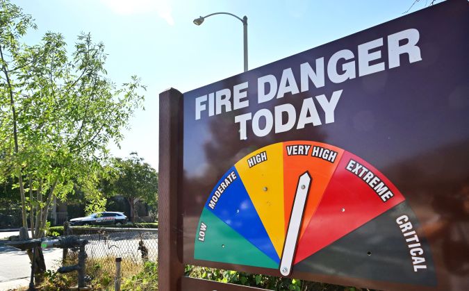 The arrow on the "Fire Danger Today" sign points to "Very High", in front of the Angeles National Forest Headquarters in Arcadia, California, on August 31, 2022. - Temperatures as high as 112 degrees Fahrenheit (44 Celsius) were expected in some Los Angeles suburbs as a huge heat dome bakes a swathe of the western United States. The sweltering weather is expected to put huge demands on the already-stretched power grid, especially when people crank up the air conditioners during the broiling hours after work and school. (Photo by Frederic J. BROWN / AFP) (Photo by FREDERIC J. BROWN/AFP via Getty Images)