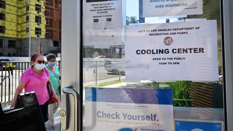 People make their way out of the heat into a cooling center at the Lafayette Recreation Center in Los Angeles, California, on September 2, 2022. Nine cooling centers opened this week in Los Angeles as Southern California deals with triple-digit temperatures during a heatwave due to last through the Labor Day weekend. (Photo by Frederic J. BROWN / AFP) (Photo by FREDERIC J. BROWN/AFP via Getty Images)