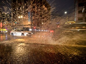 Tropical storm Kay brought rain to Southern California after a week of excessive heat with triple-digit temperatures as a vehicle is seen driving along wet streets in Hollywood, California on September 9, 2022. (Photo by Frederic J. BROWN / AFP) (Photo by FREDERIC J. BROWN/AFP via Getty Images)