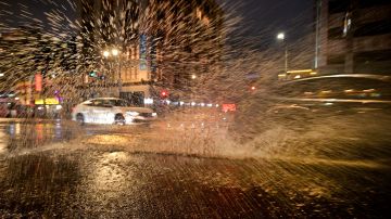 Tropical storm Kay brought rain to Southern California after a week of excessive heat with triple-digit temperatures as a vehicle is seen driving along wet streets in Hollywood, California on September 9, 2022. (Photo by Frederic J. BROWN / AFP) (Photo by FREDERIC J. BROWN/AFP via Getty Images)