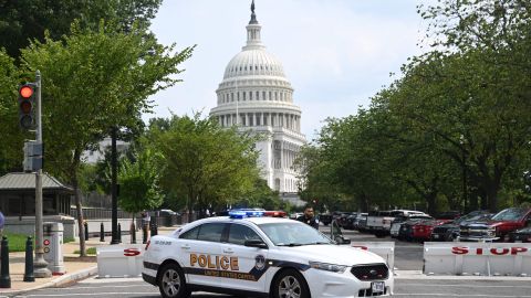 A US Capitol police officer stands by his car outside the Russell Senate Office Building in Washington, DC, on August 2, 2023, after unconfirmed eports of an active shooter in the building near the US Capitol. (Photo by SAUL LOEB / AFP) (Photo by SAUL LOEB/AFP via Getty Images)