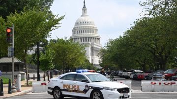 A US Capitol police officer stands by his car outside the Russell Senate Office Building in Washington, DC, on August 2, 2023, after unconfirmed eports of an active shooter in the building near the US Capitol. (Photo by SAUL LOEB / AFP) (Photo by SAUL LOEB/AFP via Getty Images)