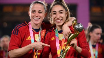 Spain's defender #02 Ona Batlle and Spain's defender #19 Olga Carmona (R) celebrate during the awards ceremony after their victory during the Australia and New Zealand 2023 Women's World Cup final football match between Spain and England at Stadium Australia in Sydney on August 20, 2023. (Photo by FRANCK FIFE / AFP) (Photo by FRANCK FIFE/AFP via Getty Images)