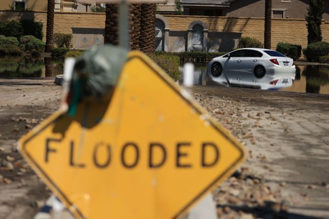 A car is pictured in a flooded street following heavy rains from Tropical Storm Hilary in Cathedral City, California, on August 21, 2023. Tropical Storm Hilary drenched Southern California with record rainfall, shutting down schools, roads and businesses before edging in on Nevada on August 21, 2023. California Governor Gavin Newsom had declared a state of emergency over much of the typically dry area, where flash flood warnings remained in effect until this morning. (Photo by DAVID SWANSON / AFP) (Photo by DAVID SWANSON/AFP via Getty Images)