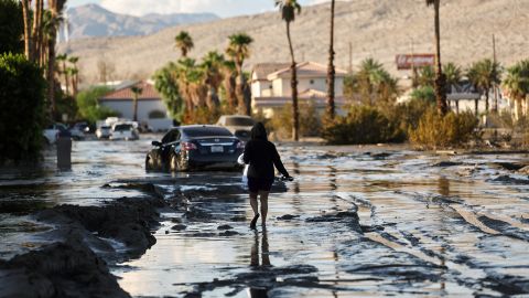 CATHEDRAL CITY, CALIFORNIA - AUGUST 21: A person walks on a flooded street on August 21, 2023 in Cathedral City, California. Much of Southern California and parts of Arizona and Nevada are cleaning up after being impacted by Tropical Storm Hilary that brought several inches of rain that flooded roadways and winds that toppled trees and power lines across the region. (Photo by Mario Tama/Getty Images)