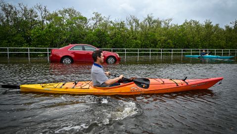 TOPSHOT - Residents use kayaks to travel on a flooded road in Tampa, Florida, on August 30, 2023, after Hurricane Idalia made landfall. Idalia barreled into the northwest Florida coast as a powerful Category 3 hurricane on Wednesday morning, the US National Hurricane Center said. "Extremely dangerous Category 3 Hurricane #Idalia makes landfall in the Florida Big Bend," it posted on X, formerly known as Twitter, adding that Idalia was causing "catastrophic storm surge and damaging winds." (Photo by Miguel J. Rodriguez Carrillo / AFP) (Photo by MIGUEL J. RODRIGUEZ CARRILLO/AFP via Getty Images)