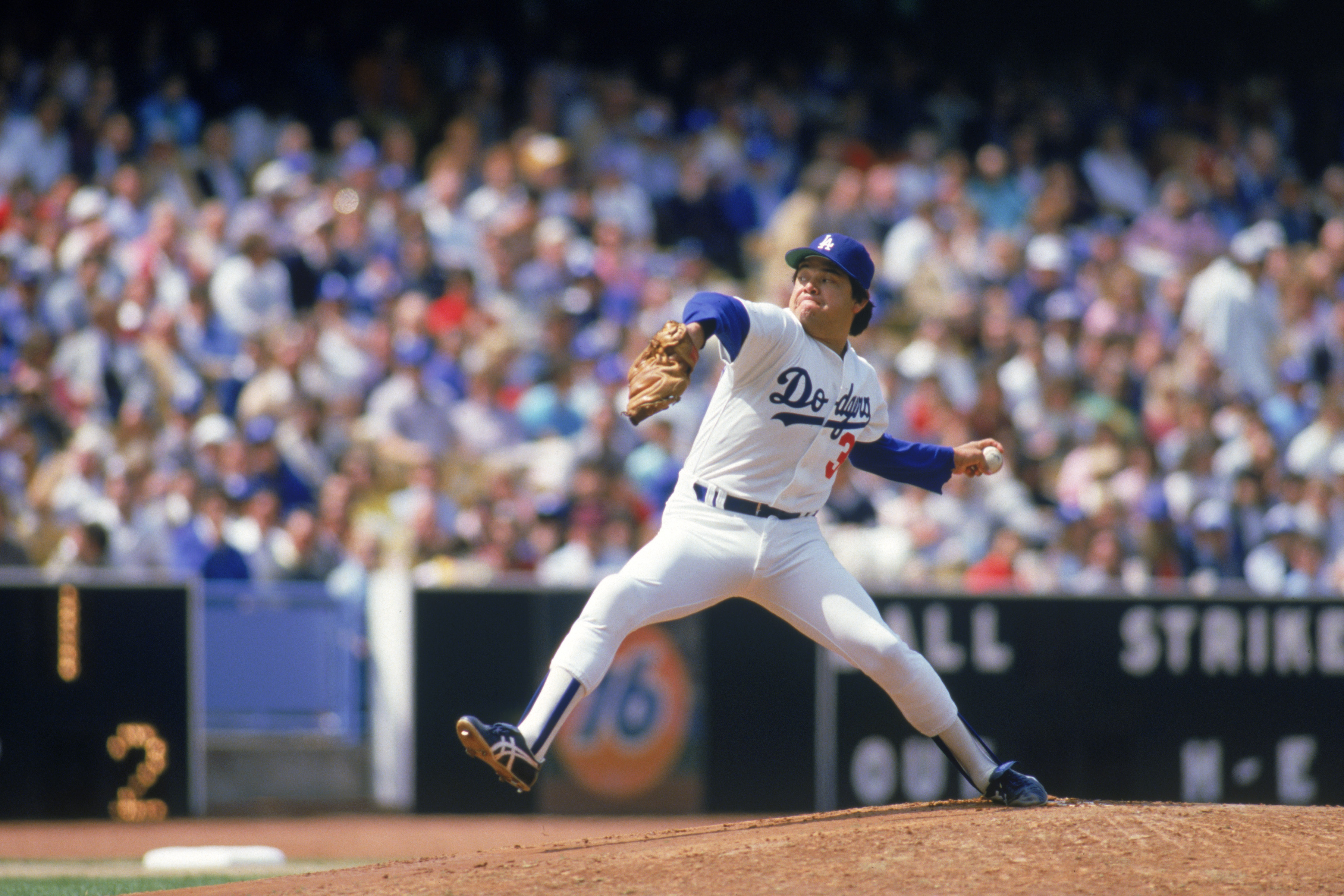 LOS ANGELES - 1985: Pitcher Fernando Valenzuela #34 of the Los Angeles Dodgers winds up for a pitch during a 1985 MLB season game at Dodger Stadium in Los Angeles, California. (Photo by: Rick Stewart/Getty Images)