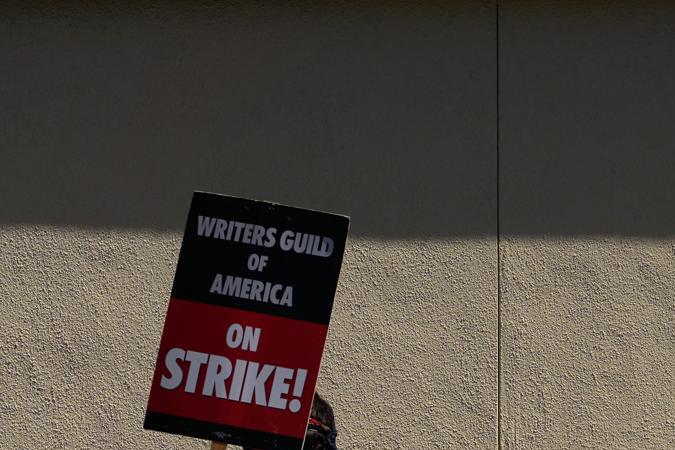 Los Angeles (United States), 07/08/2023.- A member of the Writers Guild of America (WGA) takes a sign to picket outside Paramount Studios in Los Angeles, California, USA, 07 August 2023. The Writers Guild of America (WGA) and the Alliance of Motion Picture and Television Producers (AMPTP) met on 04 August 2023 for the first time since the strike began, but they were unable to come to an agreement. EFE/EPA/ALLISON DINNER