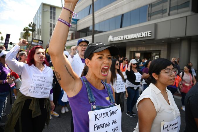 Kaiser Permanente healthcare workers, patients and their supporters march in a Labor Day protest, September 2, 2019 in Los Angeles, California. - The demonstrators were protesting what they call the healthcare giants unfair labor practices and shift from prioritizing patients to profits. More than 80,000 Kaiser Permanente workers nationwide are set to strike in early October if an agreement is not reached. (Photo by Robyn Beck / AFP) (Photo credit should read ROBYN BECK/AFP via Getty Images)