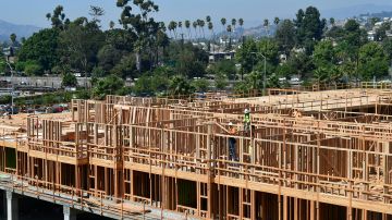 Constuction workers work on site of a new building in Los Angeles, California on October 8, 2019. California Governor Gavin Newsom will sign into law California's "anti-rent gouging" bill capping rent increases to prevent price-gouging and landlord evictions amid California's rising homeless crisis but critics say the rent caps do not solve the long-term shortage of affordable housing. (Photo by Frederic J. BROWN / AFP) (Photo by FREDERIC J. BROWN/AFP via Getty Images)