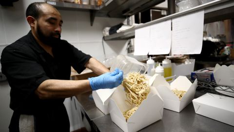 SAN FRANCISCO, CALIFORNIA - MARCH 27: Julio Mis, the executive sous chef at Sociale, prepares dinners for delivery and curbside pickup in the kitchen with a reduced staff on March 27, 2020 in San Francisco, California. Sociale is working with a staff of only four people, and are offering curbside pickup during the coronavirus (COVID-19) shutdown. On Friday nights, they are also offering delivery to the Nichol's home town of San Anselmo in Marin County just north of San Francisco. (Photo by Ezra Shaw/Getty Images)