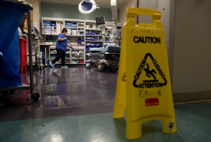 SAN JOSE, CALIFORNIA - MAY 21: (EDITORIAL USE ONLY) A worker cleans a room in the emergency room at Regional Medical Center on May 21, 2020 in San Jose, California. Frontline workers are continuing to care for coronavirus COVID-19 patients throughout the San Francisco Bay Area. Santa Clara county, where this hospital is located, has had the most deaths of any Northern California county, and the earliest known COVID-19 related deaths in the United States. (Photo by Justin Sullivan/Getty Images)