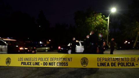 Police tape closes off a street as officers arrive on scene at Echo Park Lake in Los Angeles, March 24, 2021, ahead of a planned and announced cleanup of the encampment as part of an estimated half-million-dollar City of Los Angeles cleanup and repair effort. (Photo by Frederic J. BROWN / AFP) (Photo by FREDERIC J. BROWN/AFP via Getty Images)