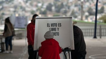 A woman casts her vote at a polling station during midterm elections in Tijuana, Mexico, on June 6, 2021. - Mexicans began voting Sunday in elections seen as pivotal to President Andres Manuel Lopez Obrador's promised "transformation" of a country shaken by the coronavirus pandemic, a deep recession and drug-related violence. (Photo by Guillermo Arias / AFP) (Photo by GUILLERMO ARIAS/AFP via Getty Images)