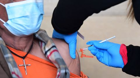 A man receives his Covid-19 vaccine at a free distribution of rapid test kits to people receiving their vaccines or boosters at Union Station in Los Angeles, California, on January 7, 2022. - Los Angeles County reported more than 37,000 new coronavirus cases on January 6, breaking records again as a regional surge of the Omicron variant continues. (Photo by Frederic J. BROWN / AFP) (Photo by FREDERIC J. BROWN/AFP via Getty Images)