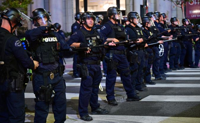 Police officers holding batons and rubber-bullet guns prepare to disperse a crowd of abortion rights activists protesting after the overturning of Roe Vs. Wade by the US Supreme Court, in Downtown Los Angeles, on June 24, 2022. - The US Supreme Court on Friday struck down the right to abortion in a seismic ruling that shredded five decades of constitutional protections and prompted several right-leaning states to impose immediate bans on the procedure. (Photo by Frederic J. BROWN / AFP) (Photo by FREDERIC J. BROWN/AFP via Getty Images)