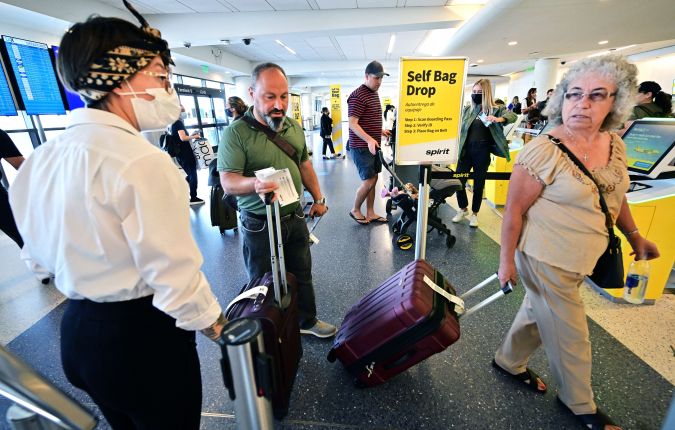Travellers check in on the depatures level at Los Angeles International Airport (LAX) on July 1, 2022, ahead of the July 4th holiday weekend. - US airlines are bracing customers for what will probably be another bumpy holiday weekend as the industry struggles to manage a surge in travel demand that probably exceeds its current capacity. (Photo by Frederic J. BROWN / AFP) (Photo by FREDERIC J. BROWN/AFP via Getty Images)