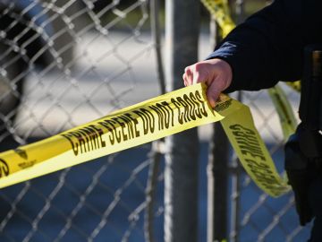 A San Mateo County Sheriff officer puts up police tape at a crime scene after a shooting at the Spanish Town shops in Half Moon Bay, California, on January 24, 2023. - A suspected gunman was in custody Monday over the killing of seven people in a rural community in northern California, just two days after a mass shooting at a Lunar New Year celebration near Los Angeles. (Photo by Samantha Laurey / AFP) (Photo by SAMANTHA LAUREY/AFP via Getty Images)