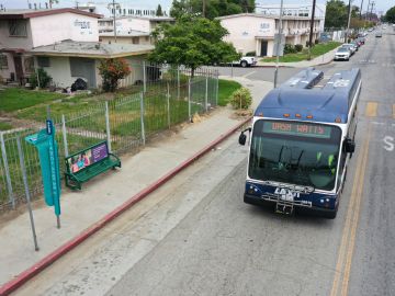 An DASH bus drives past La Sombrita, a prototype bus stop structure to provide shade during the day and solar-powered lighting at night installed by the Los Angeles Department of Transportation (LADOT) as a grant-funded pilot project for bus transit patrons, stands in the Watts neighborhood of Los Angeles, California on May 25, 2023. (Photo by Patrick T. Fallon / AFP) (Photo by PATRICK T. FALLON/AFP via Getty Images)
