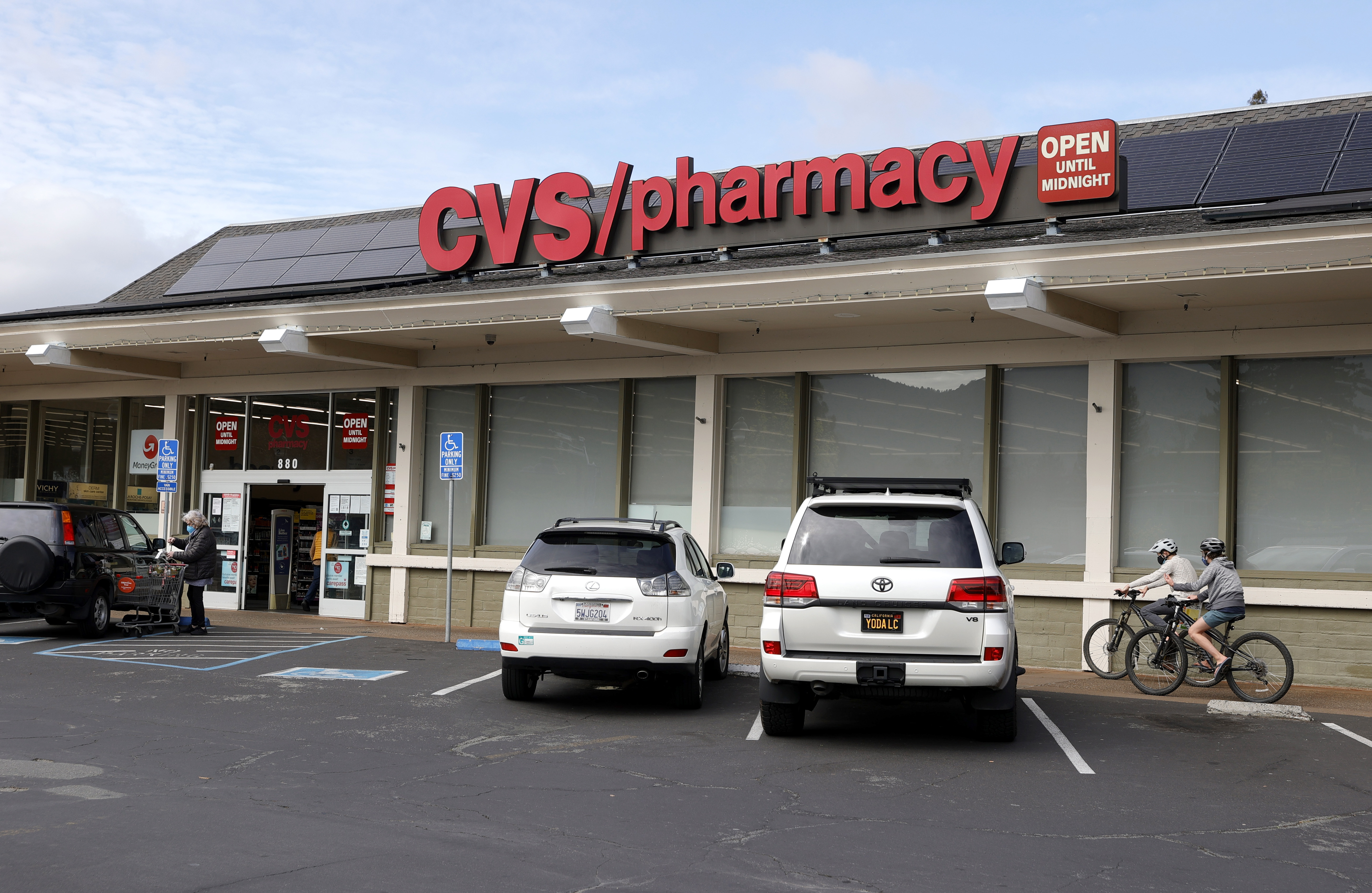 SAN ANSELMO, CALIFORNIA - FEBRUARY 16: Pedestrians walk by a CVS store on February 16, 2021 in San Anselmo, California. CVS reported better than expected fourth-quarter earnings as the retail pharmacy chain brought in new customers with COVID-19 testing and vaccines. The company's revenue was $69.55 billion compared to $66.89 billion one year ago. (Photo by Justin Sullivan/Getty Images)