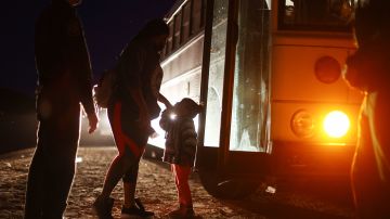YUMA, ARIZONA - MAY 18: Immigrants wait to board a U.S. Border Patrol bus to be taken for processing after crossing the border from Mexico on May 18, 2022 in Yuma, Arizona. Title 42, the controversial pandemic-era border policy enacted by President Trump, which cites COVID-19 as the reason to rapidly expel asylum seekers at the U.S. border, is set to officially expire on May 23rd. A federal judge in Louisiana is expected to deliver a ruling this week on whether the Biden administration can lift Title 42. (Photo by Mario Tama/Getty Images)