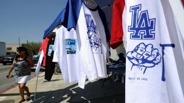 LOS ANGELES, CA - APRIL 28: Residents sell shirts commemorating the Los Angeles riots at the intersection of Florence and Normandie Avenues on April 28, 2012 in Los Angeles, California. This intersection was the location of the beating of truck driver Reginald Denny on April 29, 1992, during the early stages of the Los Angeles riots. It's been 20 years since the Rodney King verdict sparked the infamous Los Angeles riots. (Photo by Kevork Djansezian/Getty Images)