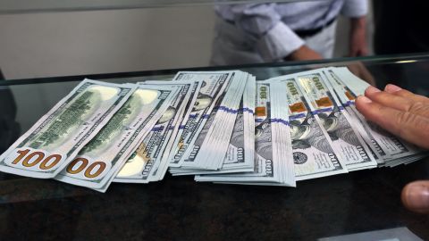 A teller shows US dollar bills at an exchange office in Ankara on July 20, 2023. Turkey's central bank hiked its main interest rate for the second month in a row, but analysts said the unwinding of President Recep Tayyip Erdogan's unconventional policy was too timid to tame inflation. After years of cuts that aimed to boost growth but fuelled inflation and caused the lira to tumble, the bank doubled its rate last month from 8.5 percent to 15 percent. The latest hike was smaller, at 2.5 percentage points, taking the rate to 17.5 percent. (Photo by Adem ALTAN / AFP) (Photo by ADEM ALTAN/AFP via Getty Images)