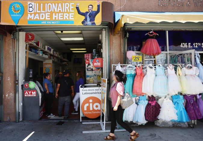 LOS ANGELES, CALIFORNIA - JULY 20: A person walks past Las Palmitas Mini Market (L) on July 20, 2023 in Los Angeles, California. The $1.08 billion winning Powerball ticket was sold at the Las Palmitas Mini Market for the July 19th drawing. The jackpot is the third largest in Powerball history and was picked after three months of drawings without a winner. The mini market is located in the downtown Fashion District close to Skid Row. (Photo by Mario Tama/Getty Images)