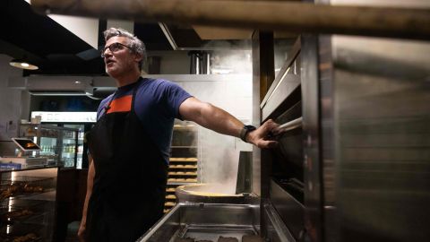 Andrew Martinez, owner of Bo's Bagels, speaks during an interview at his shop on July 12, 2023 in New York. Bagels are as synonymous with New York as pizza and the Statue of Liberty. Although there is no official count of New York's daily bagel production, Sam Silverman, chief executive of the trade group Bagelup, estimates there are about 500 specialty shops across the city's five boroughs. The ring-shaped bread has evolved and been reinvented since its arrival more than a century ago thanks to Polish Jewish immigrants. (Photo by Yuki IWAMURA / AFP) (Photo by YUKI IWAMURA/AFP via Getty Images)