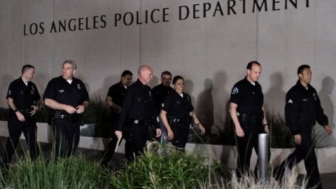 LOS ANGELES, CA - FEBRUARY 12: Police officials arrive for a media briefing outside the Police Administration Headquarters regarding former LAPD officer Christopher Dorner, February 12, 2013 in Los Angeles, California. Dorner barricaded himself in a cabin near Big Bear, California which later caught fire. According to the LAPD the cabin remains too hot to enter and a body has not been located. (Photo by Jonathan Alcorn/Getty Images)