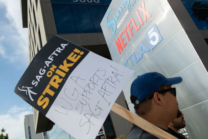 Members of the Screen Actors Guild walk a picket line outside of Netflix in Los Angeles, California, on September 27, 2023. The Writers Guild of America has been on strike since early May and the SAG-AFTRA actors' union joined the writers on the picket lines in July. (Photo by VALERIE MACON / AFP) (Photo by VALERIE MACON/AFP via Getty Images)