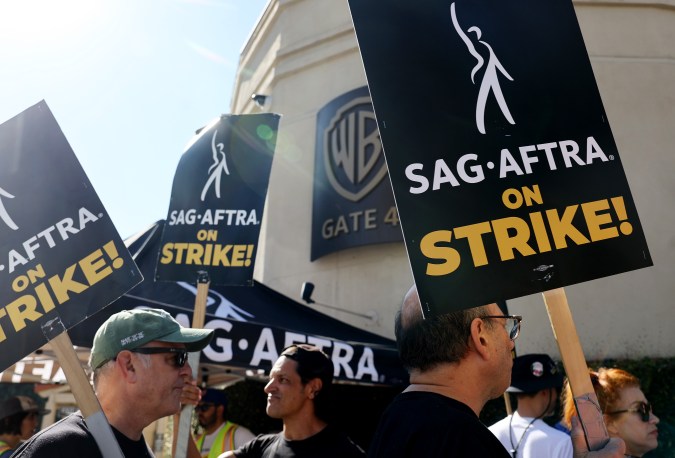 BURBANK, CALIFORNIA - SEPTEMBER 26: Striking SAG-AFTRA members picket outside Warner Bros. Studio as the actors strike continues on September 26, 2023 in Burbank, California. Hollywood is awaiting the final vote on a tentative contract agreement between over 11,000 Writers Guild of America (WGA) members and Hollywood studios in the nearly 150-day writers strike. (Photo by Mario Tama/Getty Images)
