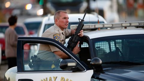 SAN BERNARDINO, CA - DECEMBER 02: A California Highway Patrol officer stands with his weapon as authorities pursued the suspects in a shooting that occurred at the Inland Regional Center on December 2, 2015 in San Bernardino, California. Police continue to search for suspects in the shooting that left at least 14 people dead and another 17 injured. (Photo by Sean M. Haffey/Getty Images)