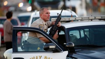 SAN BERNARDINO, CA - DECEMBER 02: A California Highway Patrol officer stands with his weapon as authorities pursued the suspects in a shooting that occurred at the Inland Regional Center on December 2, 2015 in San Bernardino, California. Police continue to search for suspects in the shooting that left at least 14 people dead and another 17 injured. (Photo by Sean M. Haffey/Getty Images)