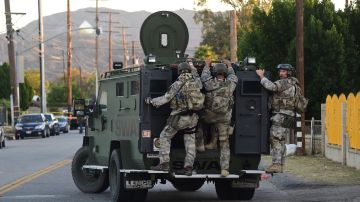 Swat police arrive at a neighborhood in San Bernardino near the intersection of Richardson and Gould where a house was searched on December 2, 2015. A man and a woman suspected of carrying out a deadly shooting at a center for the disabled in California were killed in a shootout with police, while a third person was detained, police said. AFP PHOTO / FREDERIC J. BROWN / AFP / FREDERIC J. BROWN (Photo credit should read FREDERIC J. BROWN/AFP via Getty Images)