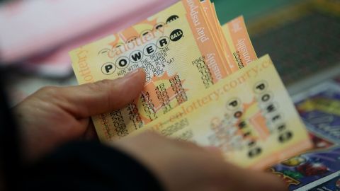 SAN LORENZO, CA - JANUARY 13: A customer buys Powerball tickets at Kavanagh Liquors on January 13, 2016 in San Lorenzo, California. Dozens of people lined up outside of Kavanagh Liquors, a store that has had several multi-million dollar winners, to -purchase Powerball tickets in hopes of winning the estimated record-breaking $1.5 billion dollar jackpot. (Photo by Justin Sullivan/Getty Images)